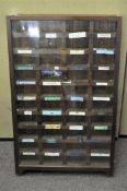 A stained oak glazed collector's display cabinet, with pigeon holes,