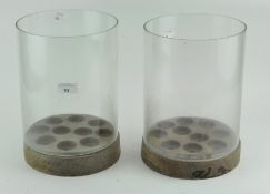 A pair of unusual cylindrical wooden and glass candle holders,