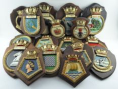 A collection of wooden mounted painted armorial badges (17) Each approximately 25 cm long