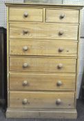 A large pine chest of drawers, comprising two short and five long drawers,