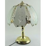 A modern gilt metal three light table lamp with opaque floral shade, 52 cm,