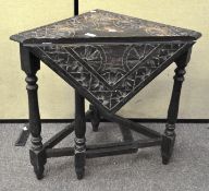 A Victorian folding corner table, heavily carved with floral motifs,