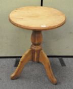 A vintage pine pub table, raised upon tripod base,