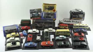 A selection of vintage die cast model vehicles, some mounted on stands,