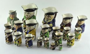 A collection of assorted Staffordshire pottery Toby Jugs,