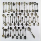 A collection of silver plated commerative spoons from around the world,