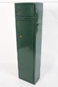 A metal two door gun cabinet, for six guns, with an upper locker, with ERA locks and keys,