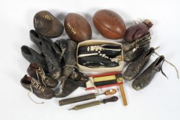 A collection of assorted early-mid 20th century sporting items, to include rugby balls,