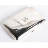 A George V silver cigar case of rectangular curved form with engraved coat of arms to the lid,