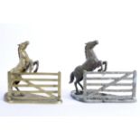 A pair of equestrian brass book ends cast as horses leaping a gate, on shaped rocky ground base,