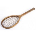 A child's vintage wooden tennis racquet,