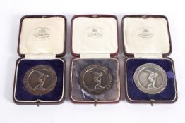 A 1920's 'Health, Strength and Loyalty' silver medal, dated 1927; together with two bronze examples,