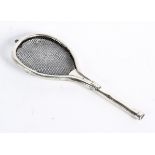 An unusual early 20th century tea strainer in the form of a Tennis racket,