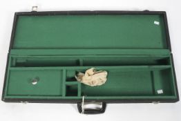 A wooden gun case with twin locks and keys,