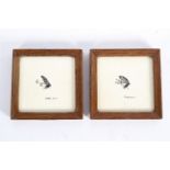 Two cream-glazed ceramic tiles within oak frames, depicting fishing flies,