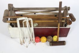 A collection of vintage wooden croquet items, to include a brass-mounted mallet and others, balls,