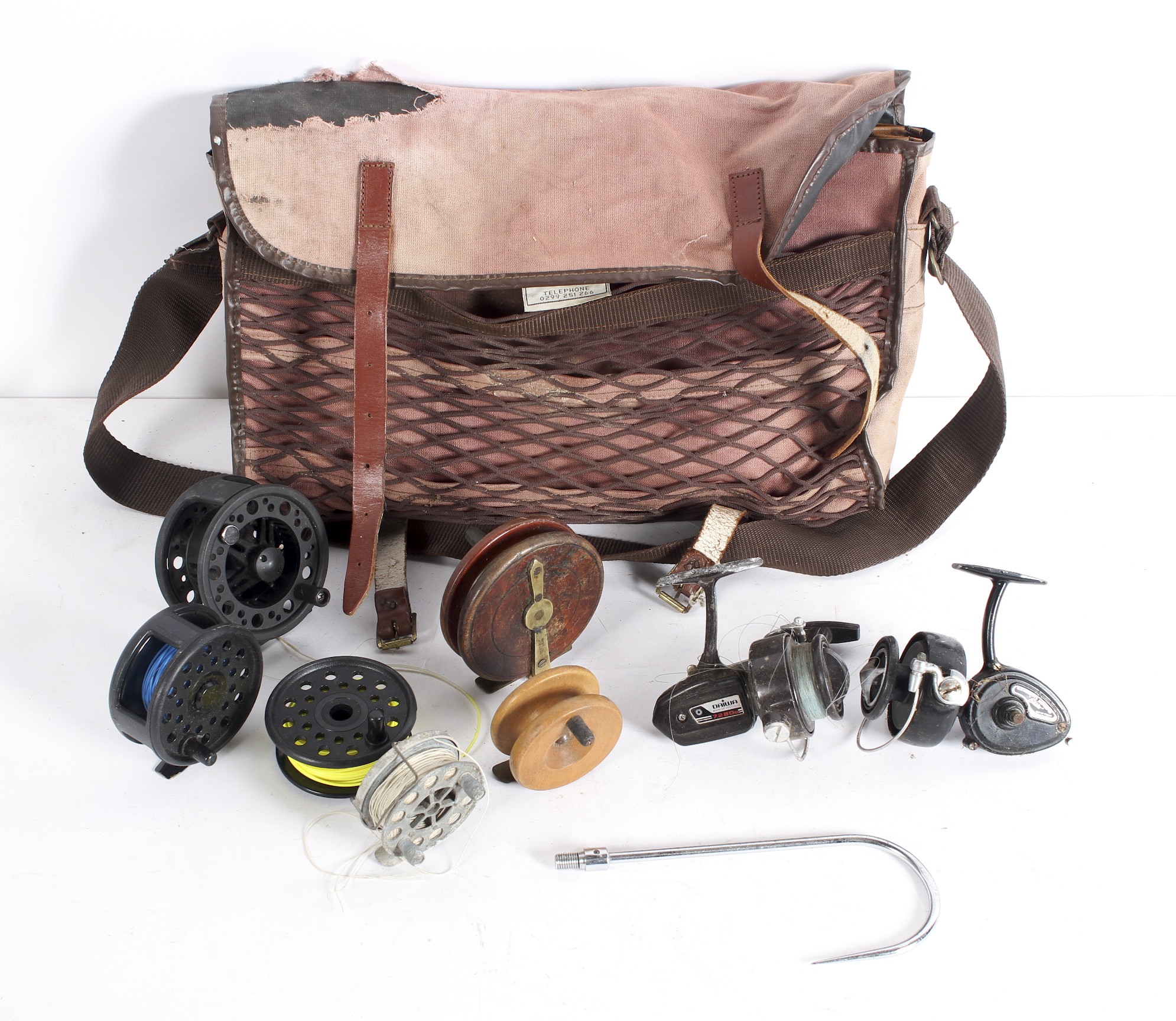 A fishing bag containing a collection of fixed spool and centre pin reels