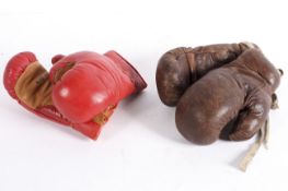 Two pairs of vintage leather boxing gloves including a brown leather pair bearing a label for Sykes