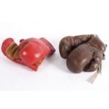 Two pairs of vintage leather boxing gloves including a brown leather pair bearing a label for Sykes