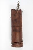 A contemporary antique style brown leather punch bag with brass chain for hanging,