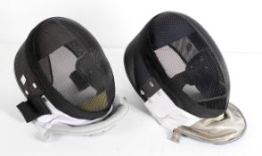 Two fencing masks, bearing labels for Enlighten (Hong Hong, 350 NW R.Tissu),