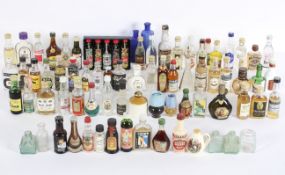 A group of miniature bottles of alcohol, including Campari, Vodka, assorted flavoured liquors,