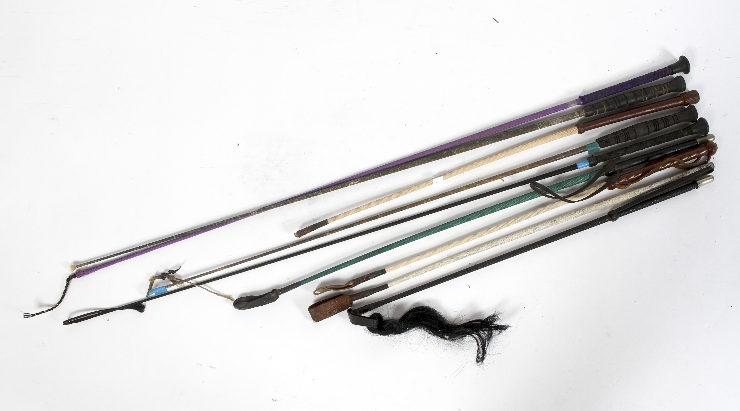 Nine riding crops, including leather mounted examples,