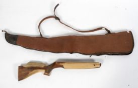 A canvas and sheep skin lined gun case, 115cm long; and a gun stock,