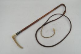 A cane riding crop with horn handle, the silver ferrule dated London 1929,