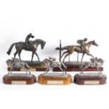 Five equestrian sculptures or trophies, comprising: three silver trophies for races in 2008...