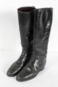 A pair of vintage black leather riding boots,