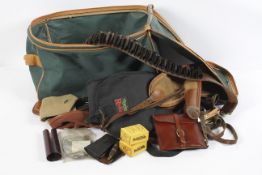 A bag of gun related items, including canvas gun slips, leather ammunition belt,