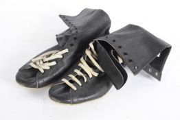 A pair of boxing boots, in black leather with cream laces,