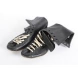 A pair of boxing boots, in black leather with cream laces,