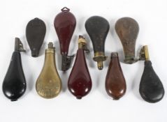 A collection of nine assorted gun powder flasks,