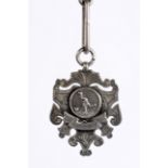 A silver football medal and large silver link chain, the medal of escutcheon shape,