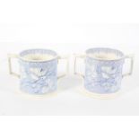 A pair of pearlware blue and white loving cups, printed with a rose flower design,