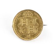 A half sovereign coin dated 1887 with a soldered pin and c catch brooch attachment.