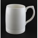 A Wedgwood Keith Murray cream-glazed mug, circa 1950, printed blue KM and Wedgwood marks,
