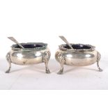 A pair of early Victorian silver open salts in the cauldron form, each raised upon three feet,
