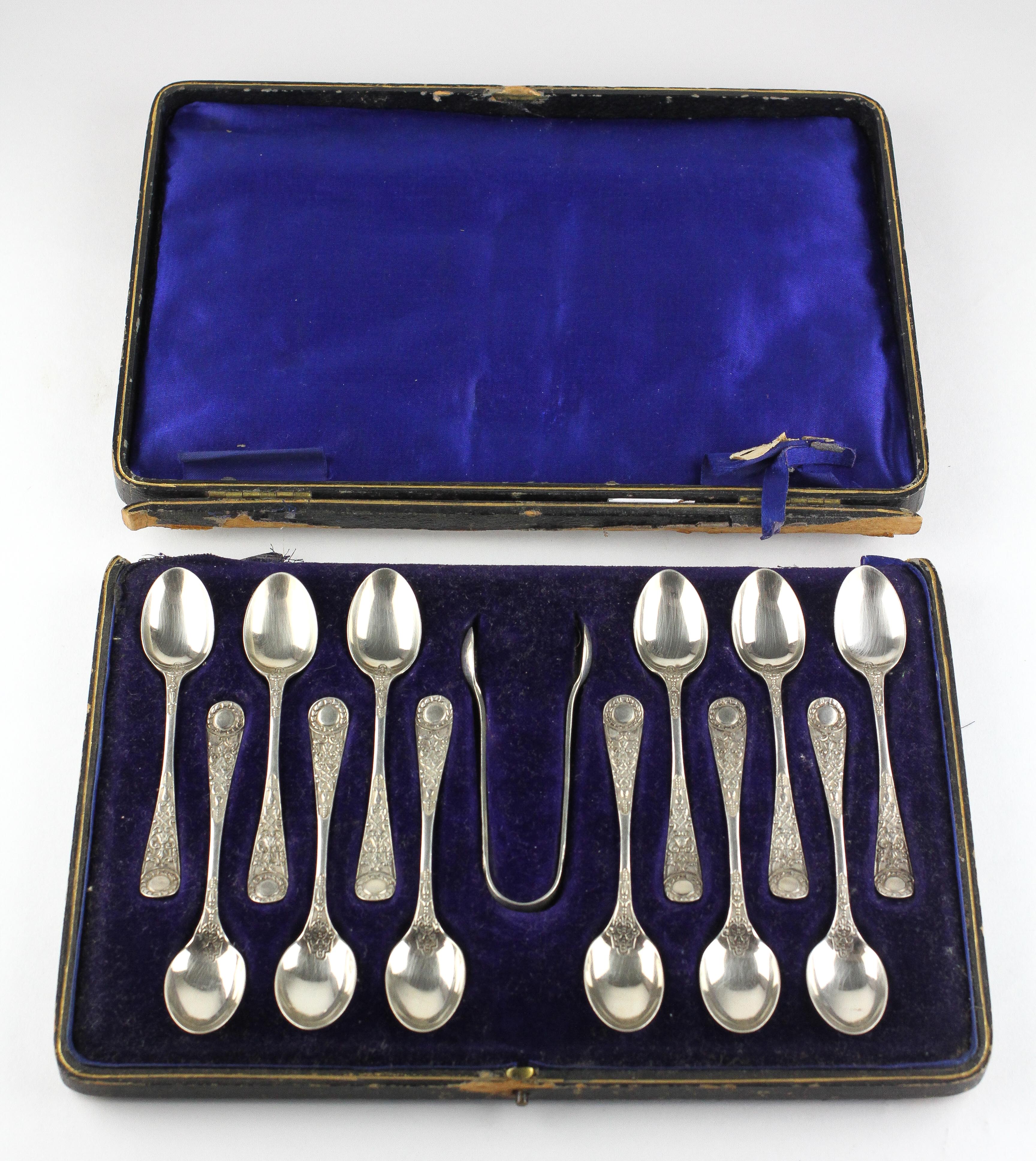 An early 20th century cased set of twelve silver teaspoons with matching sugar tongs, - Image 2 of 3