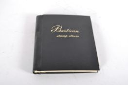 A Barbican Stamp album, mounted with First Day Covers, an `1855 Penny Red stamp,