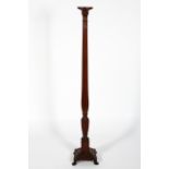 A Georgian style mahogany torchere, with reeded column and stepped square base,