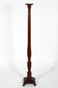 A Georgian style mahogany torchere, with reeded column and stepped square base,
