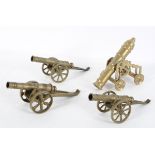 Four miniature brass cannons, in various styles,