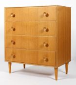 A Meredew 1960's golden oak straight four chest of drawers having shaped knob handles