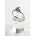 A white metal solitaire ring. Set with an old European cut diamond estimated to weigh 0.91cts.