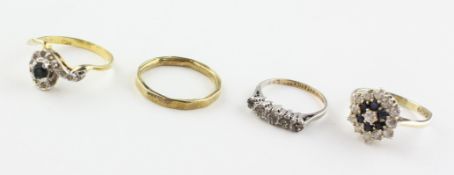 A collection of four dress rings. Three are marked for silver of variable standards.