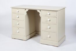 A painted twin pedestal desk or dressing table, with two runs of four graduated drawers,