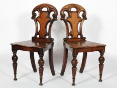 A pair of Victorian mahogany and oak hall chairs, late 19th century,